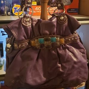 Purple purse with stones on front.